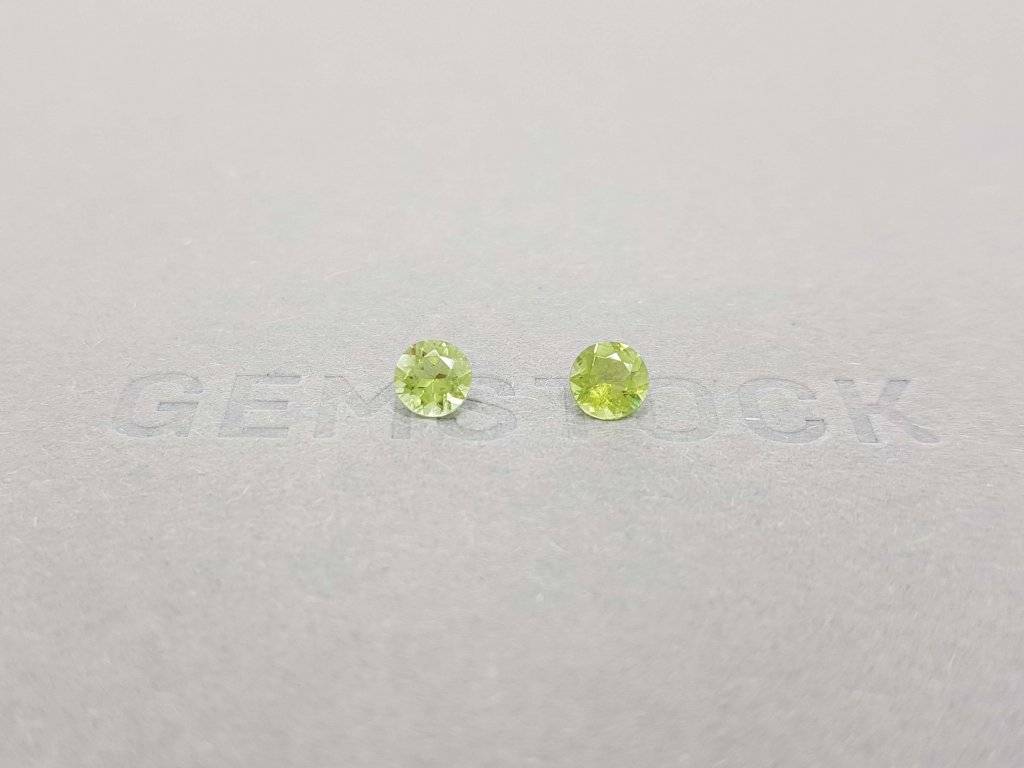 A pair of bright green tourmalines in a 5 mm round cut Image №1